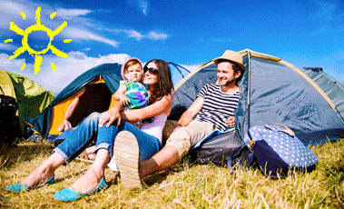 Family sat outside tent at a festival